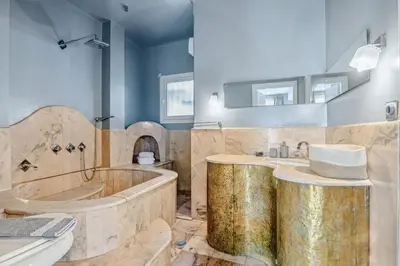a large bathroom with a tub and a sink at the Acropolis Noir Penthouse in Athens