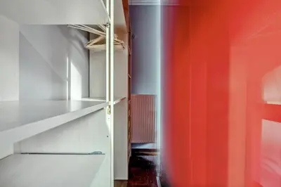 an empty closet with an orange and white wall at the Acropolis Noir Penthouse in Athens