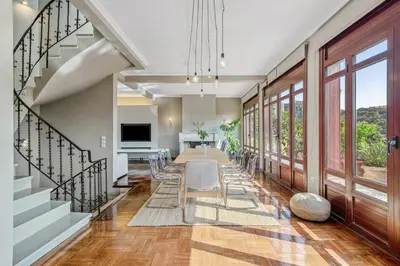 a dining room with a long table and chairs at the Acropolis Noir Penthouse in Athens