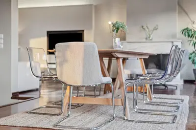 a dining room table with three chairs around it at the Acropolis Noir Penthouse in Athens