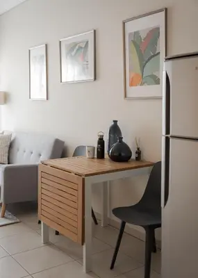 a kitchen with a table and a refrigerator at Athenian Comfort Apartments in Athens