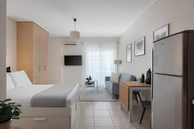 a hotel room with a bed and a desk at Athenian Comfort Apartments in Athens