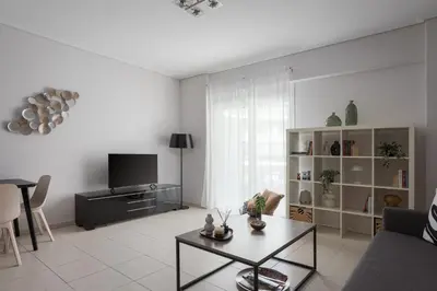 a living room with a couch and a table at Athenian Comfort Apartments in Athens