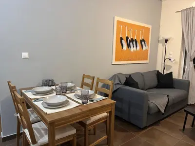 a living room with a table and a couch at Athens view penthouse with private parking in Athens