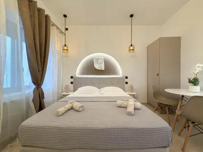 a bedroom with a bed with two towels on it at A modern temple of Athena 1 & 2 in Athens