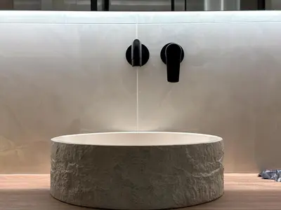 a round concrete table with speakers on a wall at A modern temple of Athena 1 & 2 in Athens