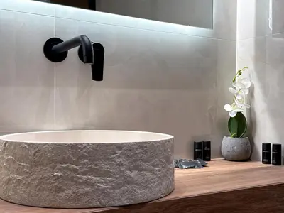 a bathroom with a marble sink and a faucet at A modern temple of Athena 1 & 2 in Athens