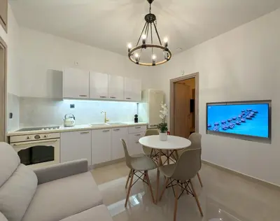 a kitchen and living room with a table and a couch at A modern temple of Athena 1 & 2 in Athens
