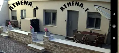 a patio with a table and chairs in front of a building at A modern temple of Athena 1 & 2 in Athens