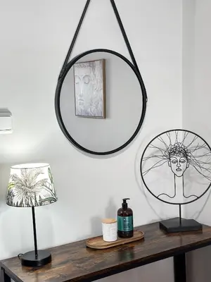 a mirror on a wall above a table with a lamp at Sea the City - Chic 2-BDR Escape with Spacious Living in Athens