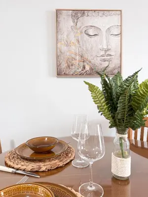 a table with two glasses and a plant on it at Sea the City - Chic 2-BDR Escape with Spacious Living in Athens