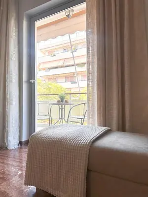a bedroom with a bed and a large window at Sea the City - Chic 2-BDR Escape with Spacious Living in Athens