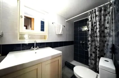 a bathroom with a sink and a toilet and a shower at Voula Family Home in Athens