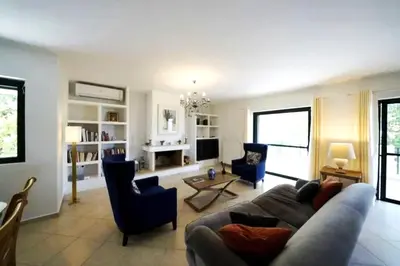 a living room with a couch and chairs at Voula Family Home in Athens