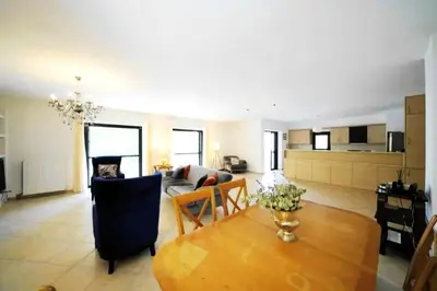 a living room with a table and a couch at Voula Family Home in Athens