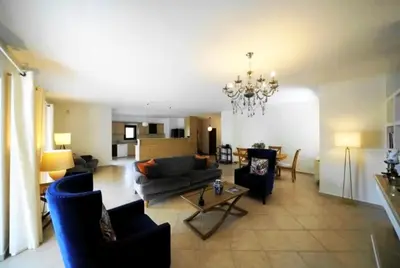 a living room with a couch and chairs and a table at Voula Family Home in Athens