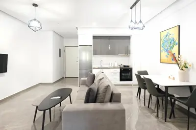 a living room with a couch and a table at Cozy Home With Cooking Near Tram in Piraeus