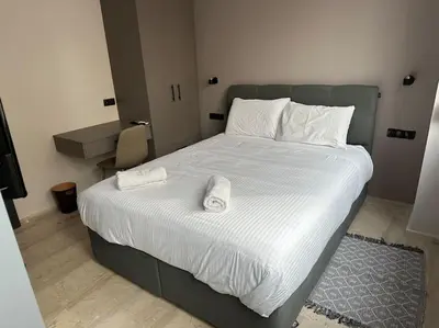 a bedroom with a bed with two towels on it at Port Brown Suite 1 in Piraeus