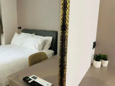 a room with a bed and a remote control on a table at Port Brown Suite 1 in Piraeus