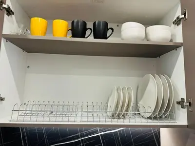 a shelf with cups and plates and bowls on it at Port Brown Suite 1 in Piraeus