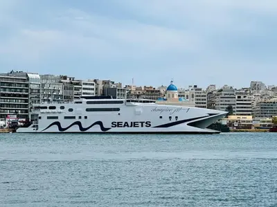 a large boat in the water with buildings in the background at Port Brown Suite 1 in Piraeus
