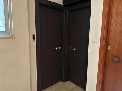 a hallway with black doors in a room at Port Brown Suite 2 in Piraeus