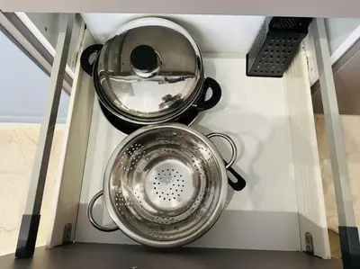 two pots and pans in a shelf in a kitchen at Port Brown Suite 2 in Piraeus