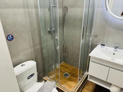 a bathroom with a shower and a toilet and a sink at Blue Suite at Piraeus Port in Piraeus