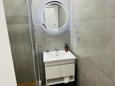 a bathroom with a sink and a mirror at Blue Suite at Piraeus Port in Piraeus