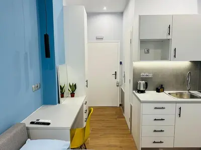 a small kitchen with white cabinets and a sink at Blue Suite at Piraeus Port in Piraeus