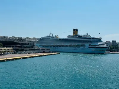 a cruise ship is docked in a harbor at Blue Suite at Piraeus Port in Piraeus