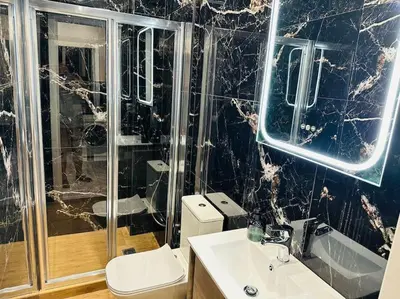a bathroom with a toilet and a sink and a shower at Grey Suite at Piraeus Port in Piraeus