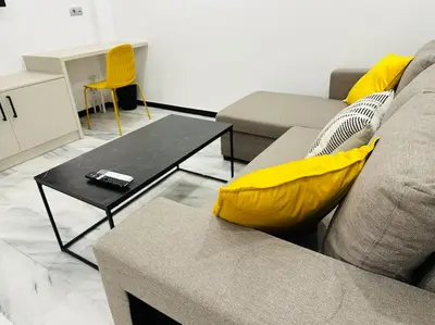 a living room with a couch and a coffee table at Grey Suite at Piraeus Port in Piraeus