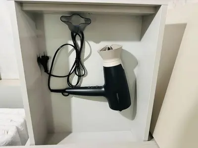 a hairdryer and a hair dryer in a cabinet at Grey Suite at Piraeus Port in Piraeus