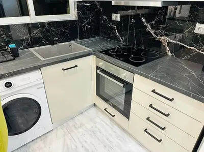 a kitchen with a stove and a washing machine at Grey Suite at Piraeus Port in Piraeus