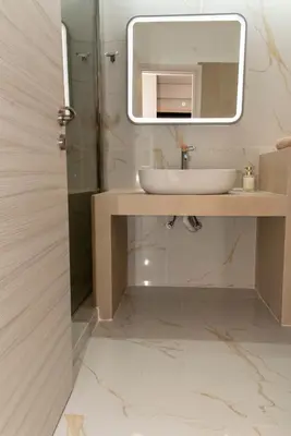 a bathroom with a sink and a mirror at Αthens Black & White Escape in Athens