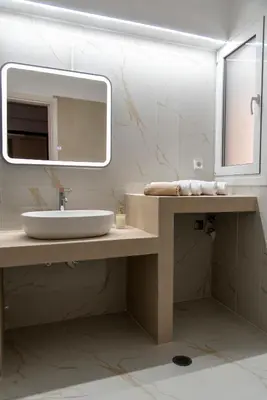 a bathroom with a sink and a mirror at Αthens Black & White Escape in Athens