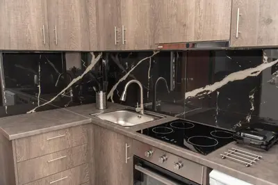 a kitchen with a sink and a stove top oven at Αthens Black & White Escape in Athens