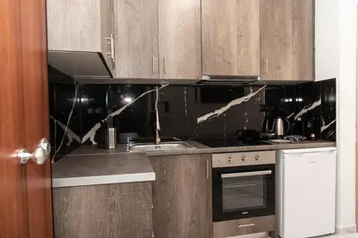 a kitchen with a sink and a stove at Αthens Black & White Escape in Athens