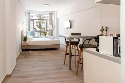 a kitchen and living room with a table and chairs at Αthens Black & White Escape in Athens