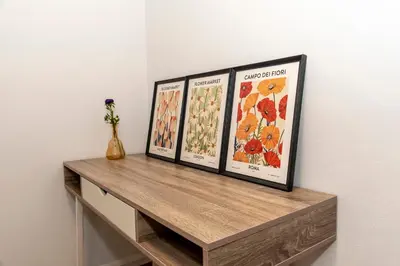 three framed posters on a shelf on a wall at Αthens Black & White Escape in Athens