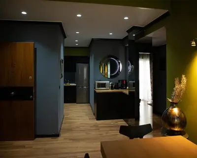 a kitchen with black and green walls and a table at Andromeda Suites in Athens