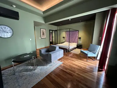 a living room with a bed and a couch at Andromeda Suites in Athens