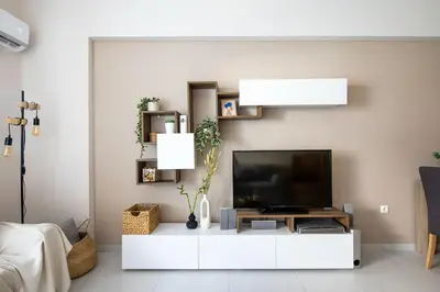 a living room with a television on a white cabinet at Casa Almera in Athens