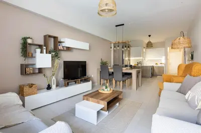 a living room with a couch and a tv and a table at Casa Almera in Athens