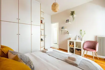 a bedroom with a bed and a pink chair at Casa Almera in Athens