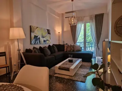 a living room with a couch and a table at Modern apartment in Neo Faliro in Piraeus
