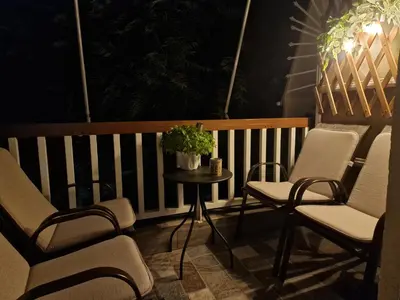 a balcony with chairs and a table with a potted plant at Modern apartment in Neo Faliro in Piraeus