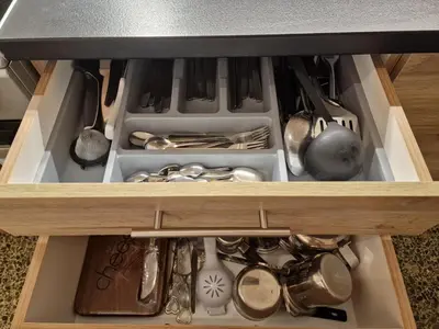 a drawer filled with utensils in a cabinet at Modern apartment in Neo Faliro in Piraeus