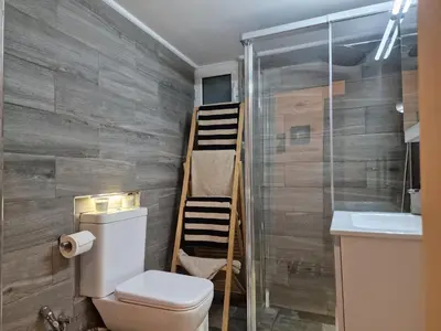 a bathroom with a toilet and a shower and a sink at Modern apartment in Neo Faliro in Piraeus